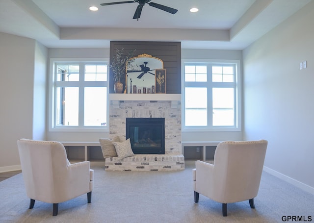 20506 Boulder St, Gretna, NE 68028 - living area featuring healthy amount of natural light, ceiling fan, a tray ceiling, a brick fireplace, and recessed lighting