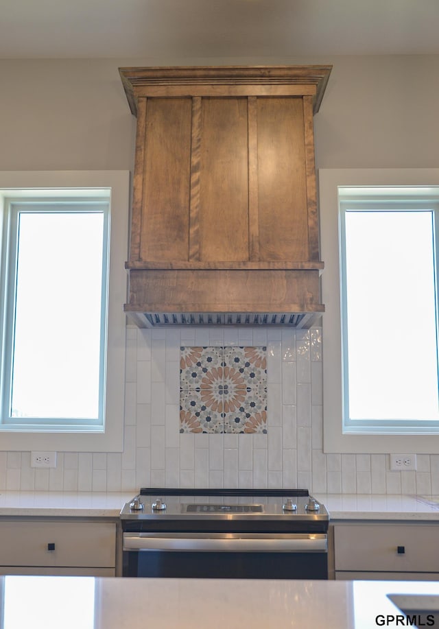 20506 Boulder St, Gretna, NE 68028 - kitchen featuring premium range hood, tasteful backsplash, stainless steel range with electric stovetop, and light countertops