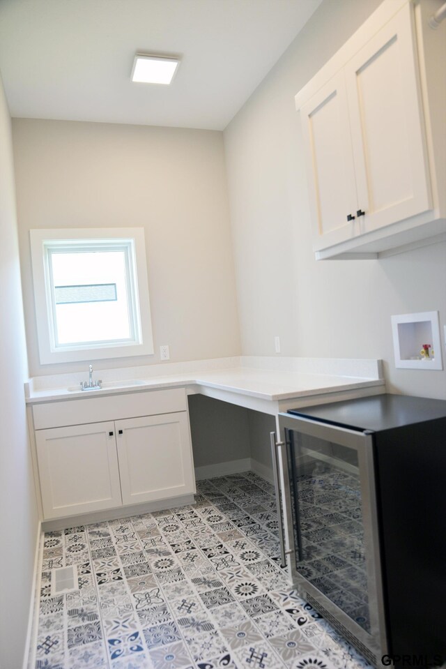 20506 Boulder St, Gretna, NE 68028 - laundry room with wine cooler, light tile patterned floors, washer hookup, and cabinet space