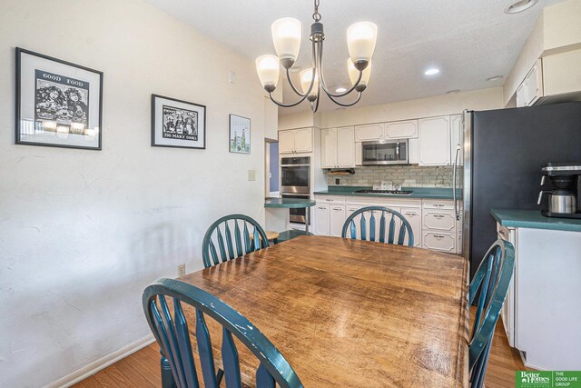 1729 S 76th Ave, Omaha, NE 68124 - dining space with a chandelier, light wood finished floors, and recessed lighting