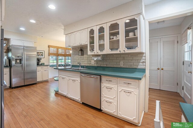 1729 S 76th Ave, Omaha, NE 68124 - kitchen with appliances with stainless steel finishes, white cabinets, decorative backsplash, recessed lighting, and dark countertops