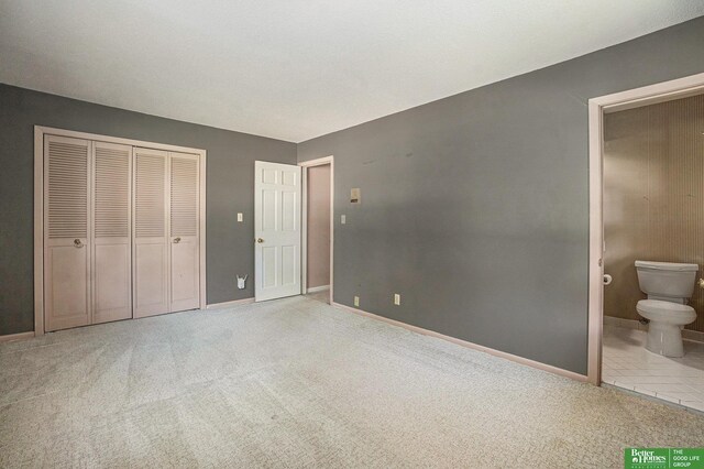 1729 S 76th Ave, Omaha, NE 68124 - unfurnished bedroom featuring carpet flooring, a closet, and connected bathroom