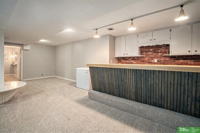 1729 S 76th Ave, Omaha, NE 68124 - kitchen featuring light carpet, white cabinetry, fridge, light countertops, and track lighting
