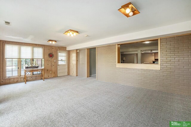 1729 S 76th Ave, Omaha, NE 68124 - empty room featuring brick wall and carpet
