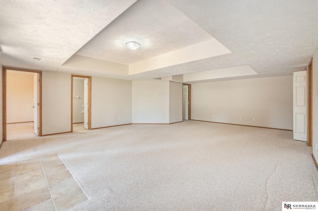4209 N 158th Ave, Omaha, NE 68116 - empty room with a textured ceiling, light colored carpet, and a tray ceiling