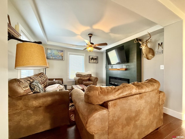 26855 SW 89th Rd, Beatrice, NE 68310 - living area featuring ceiling fan, a fireplace, dark wood-style floors, and healthy amount of natural light