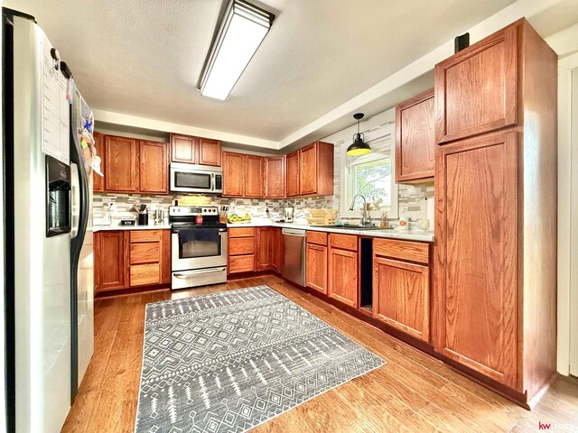 26855 SW 89th Rd, Beatrice, NE 68310 - kitchen with stainless steel appliances, light countertops, backsplash, and light wood-style flooring