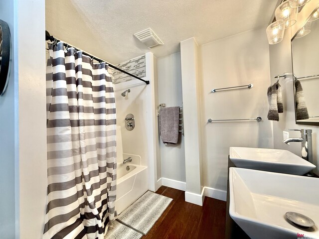 26855 SW 89th Rd, Beatrice, NE 68310 - full bathroom with shower / bath combo with shower curtain, wood finished floors, vanity, and a textured ceiling