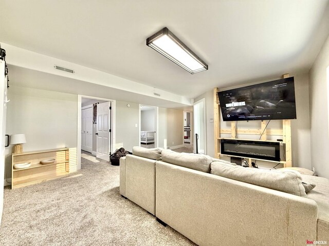 26855 SW 89th Rd, Beatrice, NE 68310 - carpeted living room featuring a glass covered fireplace and baseboards