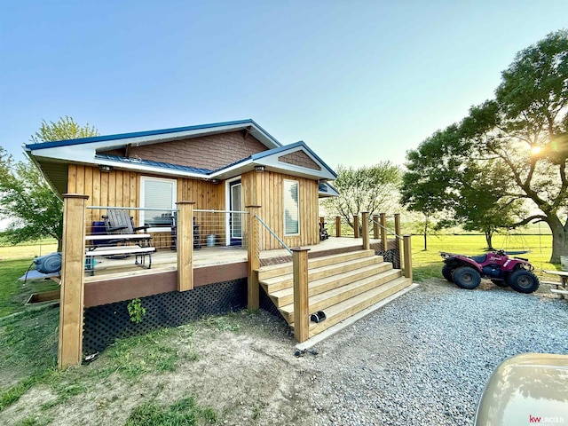 26855 SW 89th Rd, Beatrice, NE 68310 - rear view of house with board and batten siding and a wooden deck