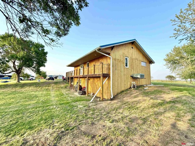 26855 SW 89th Rd, Beatrice, NE 68310 - view of side of home with a yard and a wooden deck