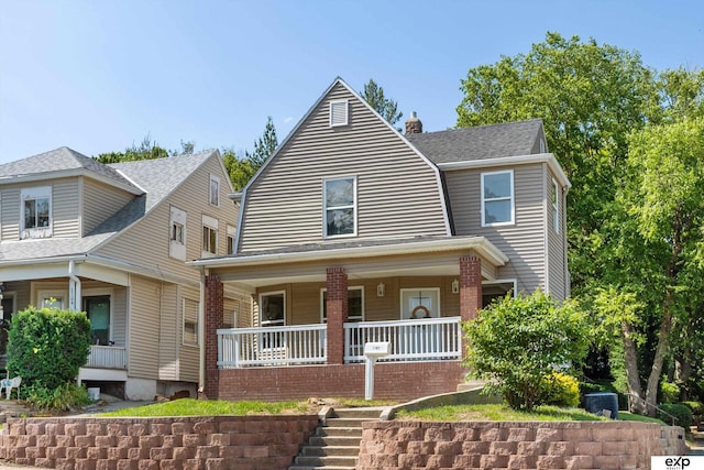 3102 Woolworth Ave, Omaha, NE 68105 - view of front of property featuring covered porch, a chimney, a shingled roof, and a gambrel roof