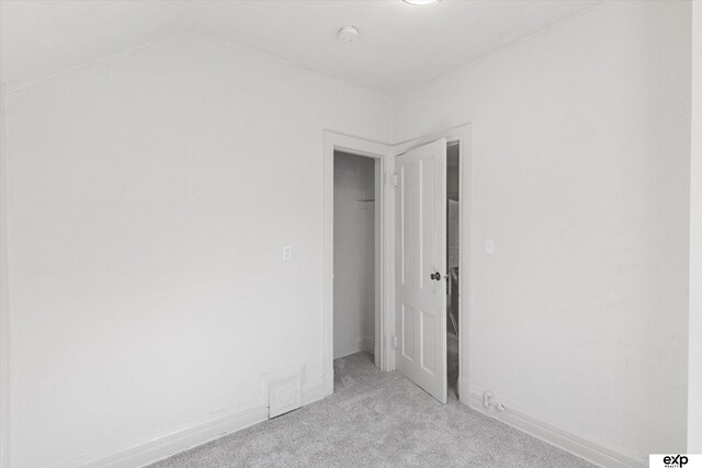 3102 Woolworth Ave, Omaha, NE 68105 - unfurnished bedroom featuring carpet, a closet, and lofted ceiling