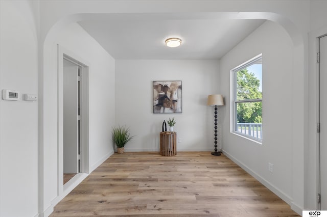 3102 Woolworth Ave, Omaha, NE 68105 - hallway with light wood-type flooring and arched walkways