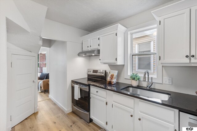 3102 Woolworth Ave, Omaha, NE 68105 - kitchen featuring stainless steel electric range, under cabinet range hood, light wood-type flooring, white cabinets, and a textured ceiling