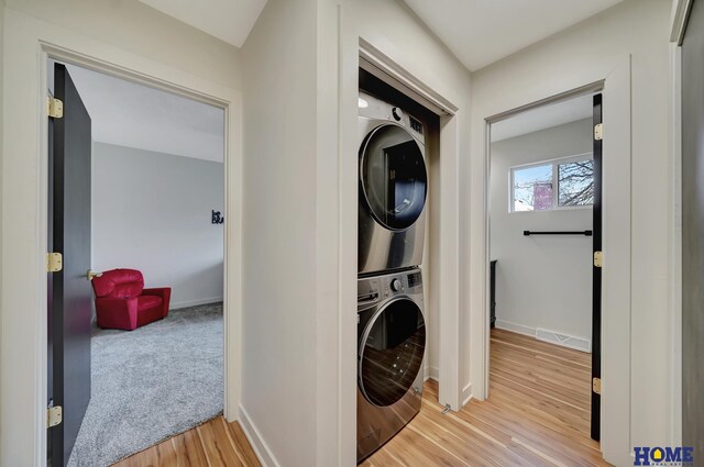 1991 Calvert St, Lincoln, NE 68502 - laundry room featuring estacked washer and dryer and light wood-style floors