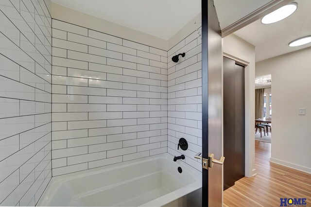 1991 Calvert St, Lincoln, NE 68502 - bathroom featuring bathing tub / shower combination and wood finished floors