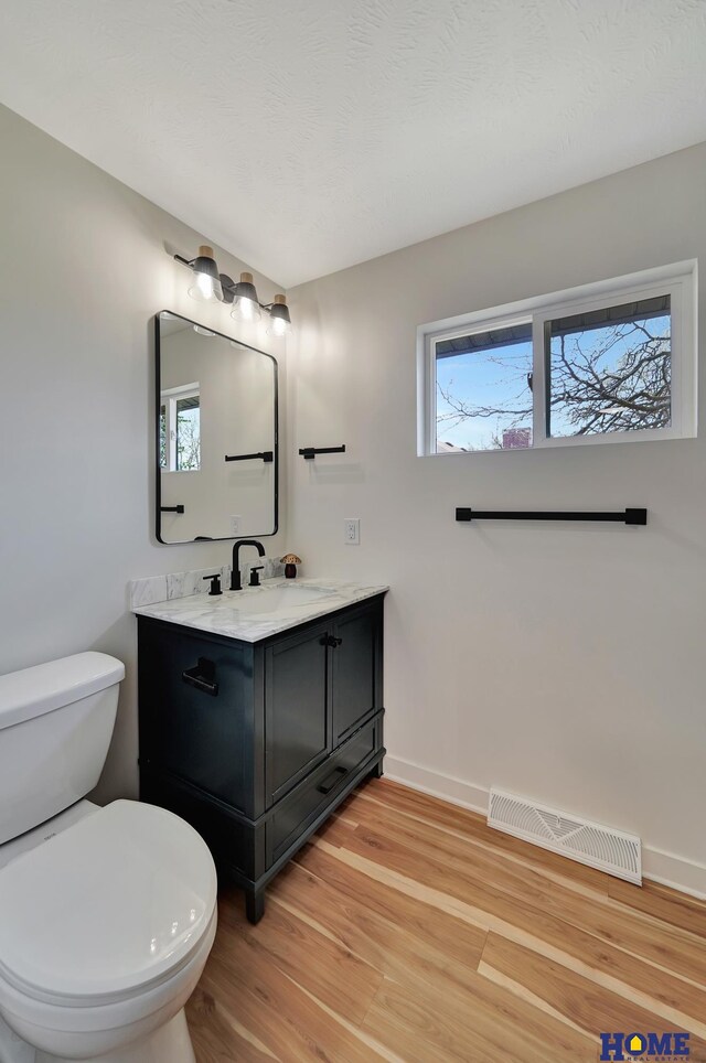 1991 Calvert St, Lincoln, NE 68502 - bathroom featuring wood finished floors and vanity