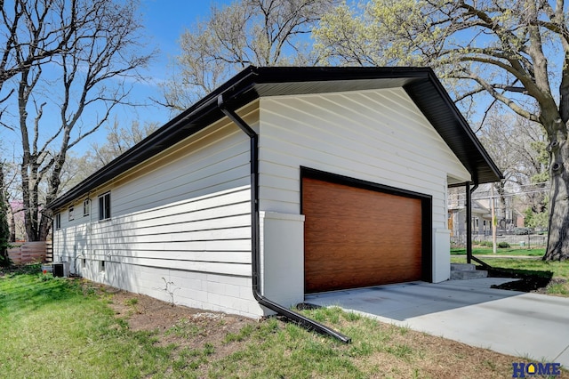 1991 Calvert St, Lincoln, NE 68502 - view of side of home with a garage and a cooling unit