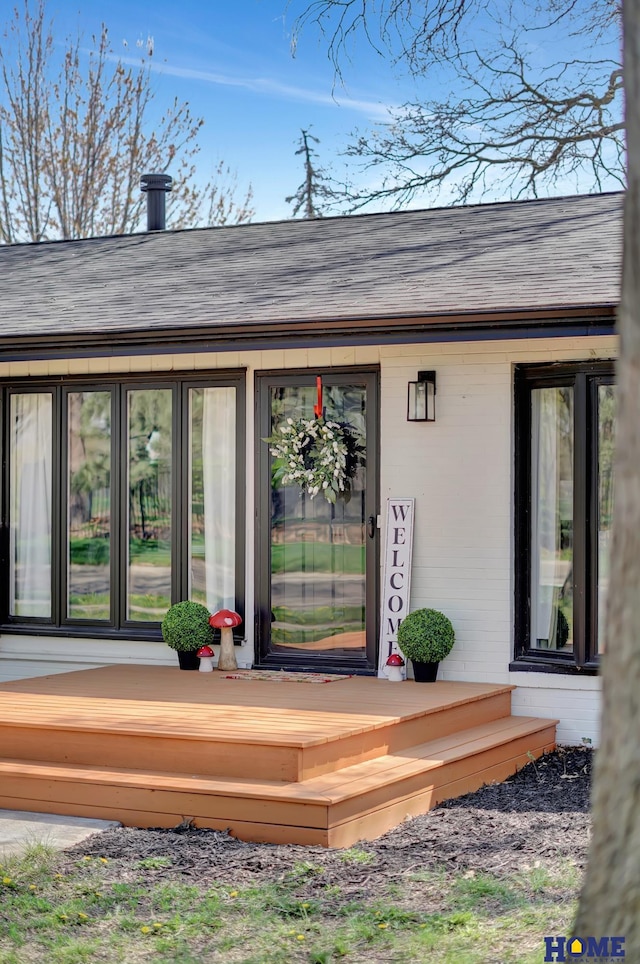 1991 Calvert St, Lincoln, NE 68502 - view of exterior entry with a shingled roof