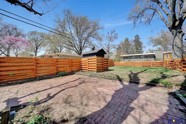 1991 Calvert St, Lincoln, NE 68502 - fenced backyard featuring a patio area and a storage unit