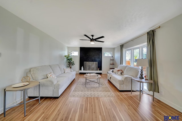 1991 Calvert St, Lincoln, NE 68502 - living area featuring light wood-type flooring, ceiling fan, and a large fireplace