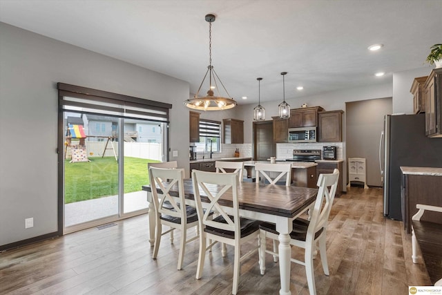 7176 N 166th St, Bennington, NE 68007 - dining area with light wood finished floors and recessed lighting