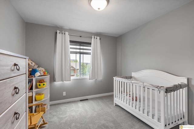 7176 N 166th St, Bennington, NE 68007 - carpeted bedroom featuring baseboards and a nursery area