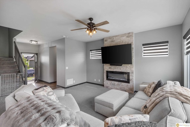 7176 N 166th St, Bennington, NE 68007 - carpeted living room with healthy amount of natural light, a ceiling fan, a stone fireplace, and stairway