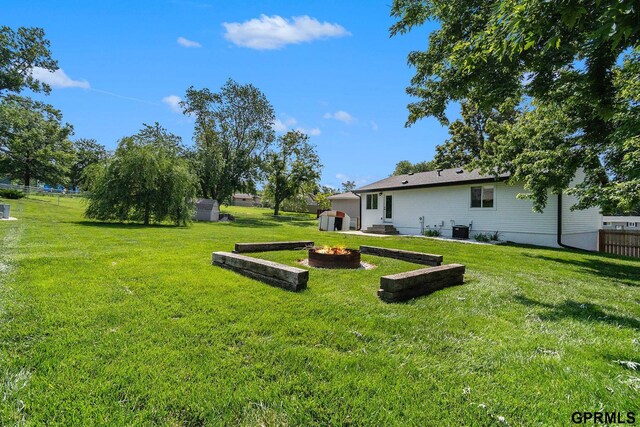 4005 N 213th Cir, Omaha, NE 68022 - view of yard featuring a fire pit and a storage unit