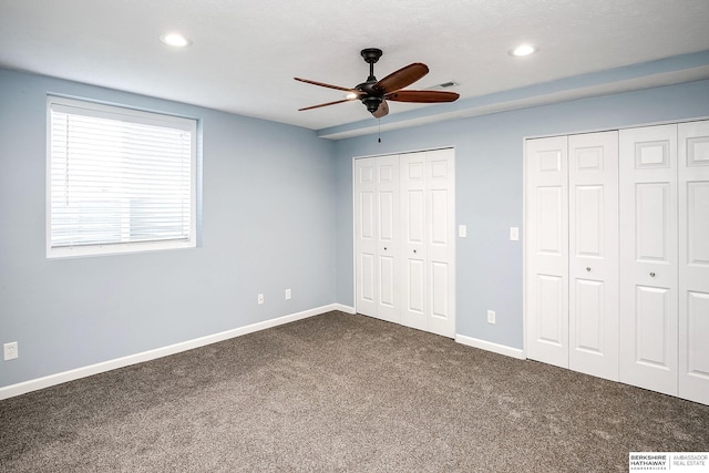 21305 Mcclellan Cir, Gretna, NE 68028 - unfurnished bedroom featuring two closets, dark colored carpet, recessed lighting, and ceiling fan