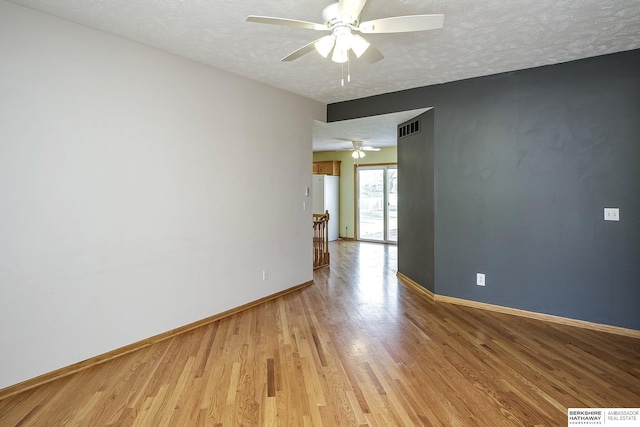 21305 Mcclellan Cir, Gretna, NE 68028 - spare room featuring ceiling fan, a textured ceiling, and light wood-type flooring