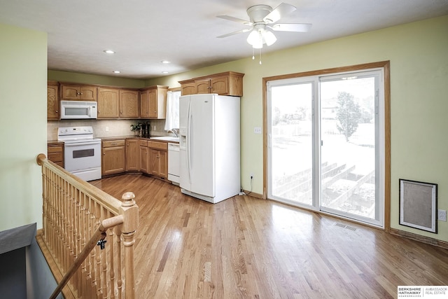 21305 Mcclellan Cir, Gretna, NE 68028 - kitchen with white appliances, light wood-type flooring, ceiling fan, recessed lighting, and decorative backsplash