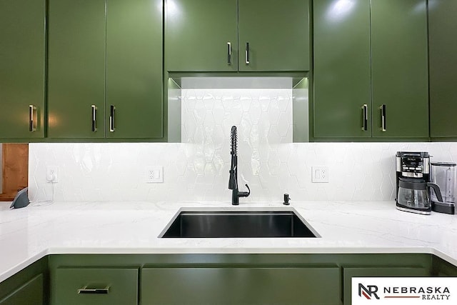 8506 Keystone Dr, Omaha, NE 68134 - kitchen with green cabinets, tasteful backsplash, and light stone counters