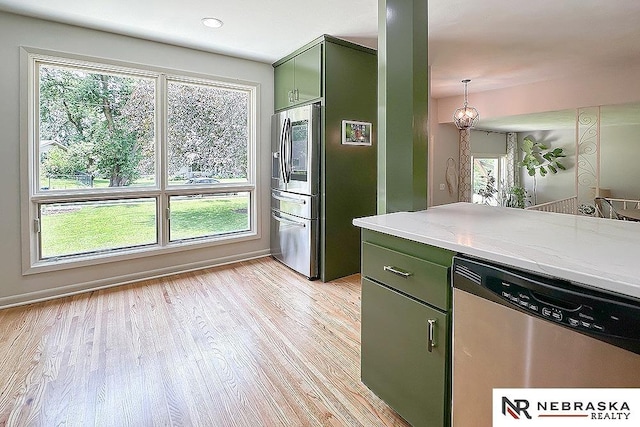8506 Keystone Dr, Omaha, NE 68134 - kitchen with green cabinets, appliances with stainless steel finishes, plenty of natural light, and light wood-style flooring