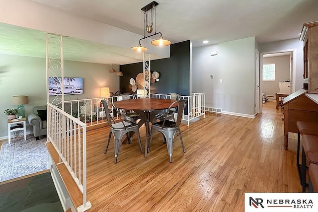 8506 Keystone Dr, Omaha, NE 68134 - dining area with light wood-type flooring and baseboards