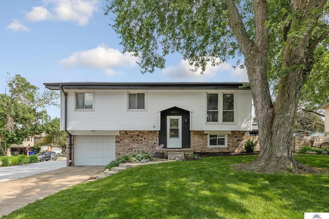 7713 Chestnut St, La Vista, NE 68128 - raised ranch featuring driveway, a garage, a front lawn, brick siding, and entry steps