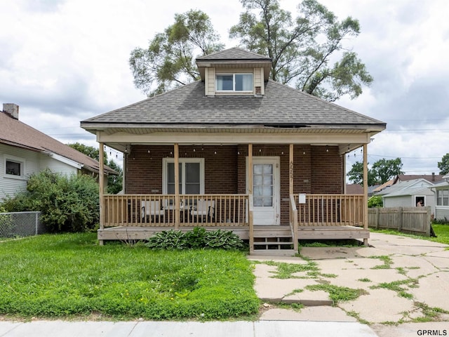 6557 Maple St, Omaha, NE 68104 - view of front facade featuring a shingled roof, brick siding, and covered porch