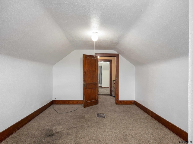 6557 Maple St, Omaha, NE 68104 - bonus room with carpet floors, lofted ceiling, and a textured ceiling