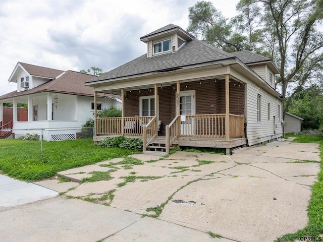 6557 Maple St, Omaha, NE 68104 - view of front of home with covered porch, brick siding, and a shingled roof