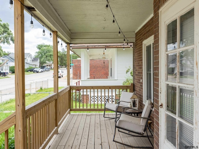 6557 Maple St, Omaha, NE 68104 - wooden porch with a residential view