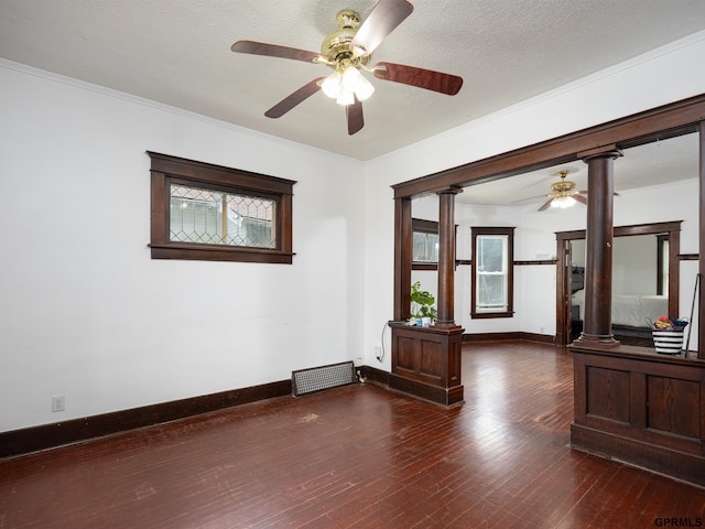 6557 Maple St, Omaha, NE 68104 - empty room with decorative columns, ceiling fan, dark wood-type flooring, and crown molding