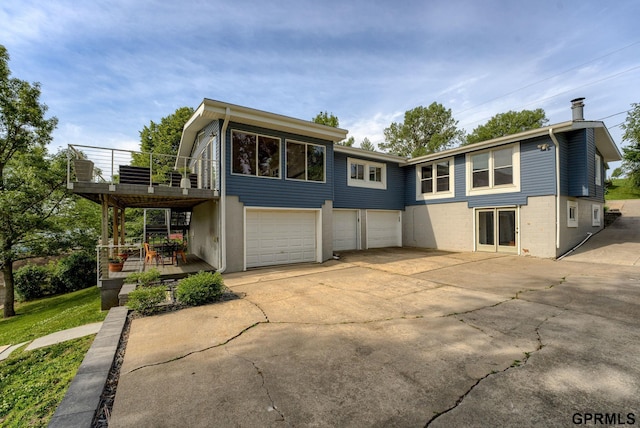 1524 Trumball Ter, Plattsmouth, NE 68048 - view of front of house with a balcony, concrete driveway, and a garage
