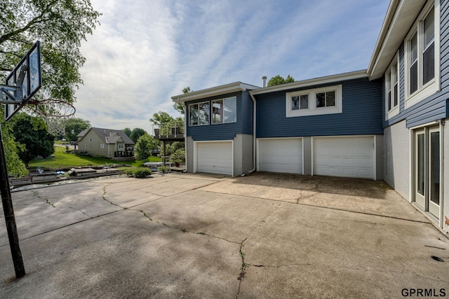 1524 Trumball Ter, Plattsmouth, NE 68048 - view of side of property with an attached garage and concrete driveway
