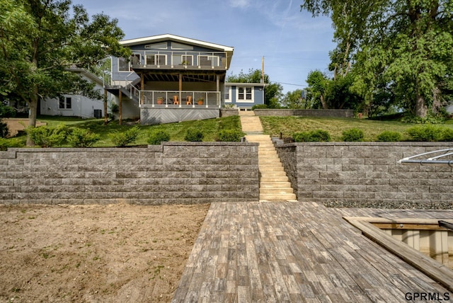 1524 Trumball Ter, Plattsmouth, NE 68048 - back of property featuring stairway, a deck, and a lawn