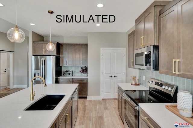 527 N 108th St, Lincoln, NE 68527 - kitchen featuring appliances with stainless steel finishes, backsplash, hanging light fixtures, light wood-type flooring, and recessed lighting