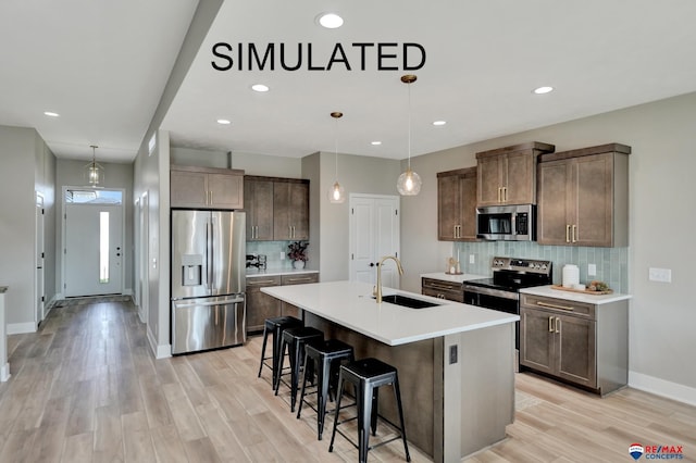 527 N 108th St, Lincoln, NE 68527 - kitchen with stainless steel appliances, tasteful backsplash, light wood-type flooring, a kitchen bar, and light countertops