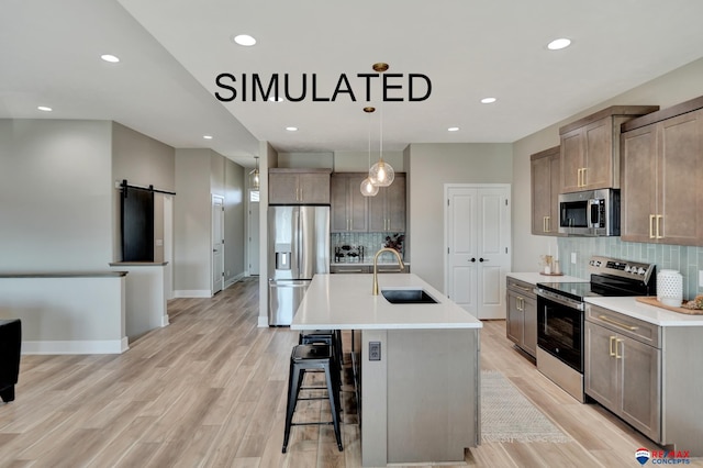 527 N 108th St, Lincoln, NE 68527 - kitchen featuring stainless steel appliances, backsplash, a kitchen breakfast bar, light countertops, and light wood-style floors