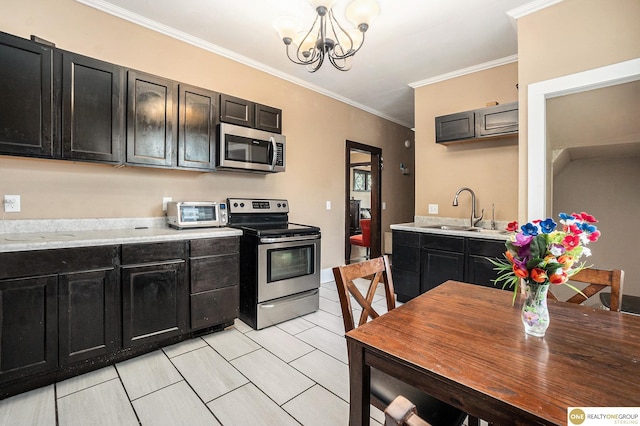 4615 N 28th Ave, Omaha, NE 68111 - kitchen featuring appliances with stainless steel finishes, dark cabinetry, light countertops, ornamental molding, and a chandelier