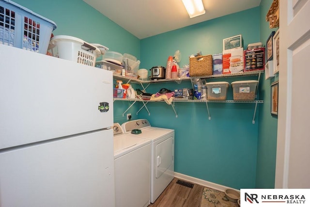15929 Rosewater Pkwy, Bennington, NE 68007 - laundry area with washing machine and dryer and wood finished floors